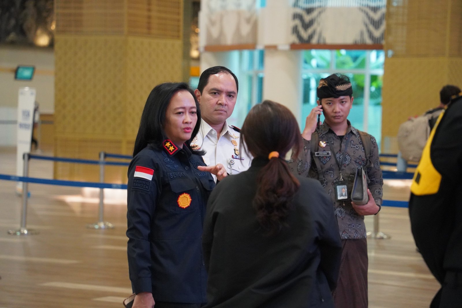 Head of Bali Immigration and Head Regional on the floor back to back making sure the line is on